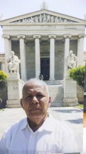Sir infront of Athens Uni statues Plato n Socrates
